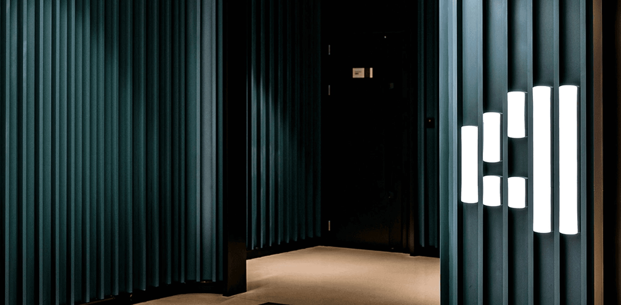 Dark architectural corridor with vertical wall lights